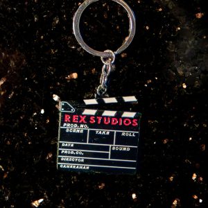 Porte clé "Rex Studios" en forme de Clap de cinéma, disponible dans la boutique du Grand Rex Paris